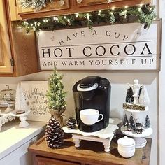 a coffee bar with christmas decorations on the counter and signs above it that read have a cup, hot cocoa and warm yourself up