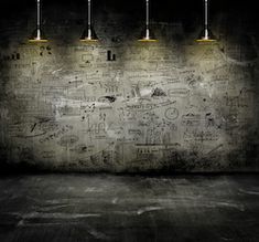 an empty room with five lights on the ceiling and graffiti all over the wall behind it