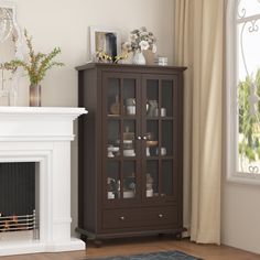 a living room with a fire place next to a window and a fireplace in the corner