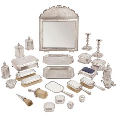 an assortment of silver items including a mirror, brush, and other objects are shown