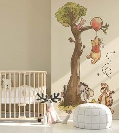 winnie the pooh wall decal in a baby's room with a crib