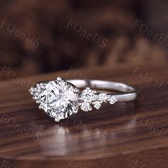 a diamond ring on top of a wooden table