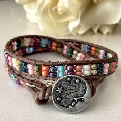 Iridescent Miyuki Seed Beads Are Stitched Onto Mocha Brown Leather Cord And Secured With A “Starry Nights Man In The Moon” Silver Pewter Button Closure. The Bracelet Measures 15 1/2 Inches Long And Has Two Knots At The End For Size Adjustment. Designed And Handcrafted By Me. Organza Jewelry Bag Included For Gift Giving Or Safe Keeping. Free Gift With Purchase! Fast Shipping! Bundle With Something Else In My Closet To Save More! Leather Beaded Bracelet, Organza Jewelry, Leather Cord Jewelry, Jump Ring Jewelry, Suede Jewelry, Suede Bracelet, Jewelry Making Business, Man In The Moon, Brighton Bracelets