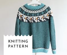 a knitted sweater hanging on a hanger with the knitting pattern in front of it