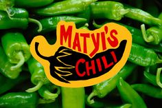 a pile of green peppers with the words matty's chili on it