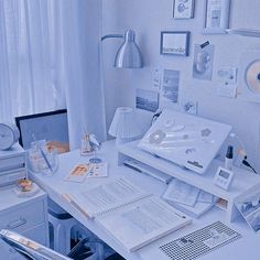 a white desk topped with lots of papers