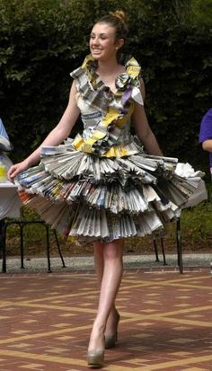 a woman in a dress made out of newspapers