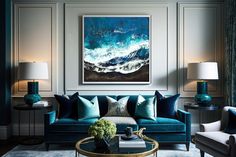 a living room with blue couches and lamps on either side of the couch is a large painting