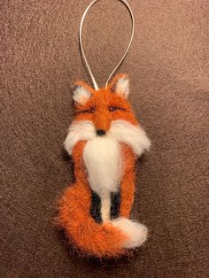 an ornament made to look like a fox sitting on top of a carpet