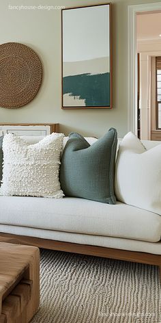 a living room with a couch, coffee table and pictures on the wall above it