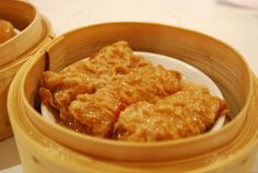 two wooden containers filled with food on top of a table