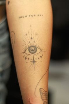 a person with a tattoo on their arm that says room for all and an eye