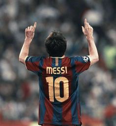 a soccer player with his hands up in the air while wearing a jersey that says messi