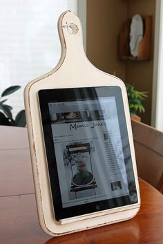 an ipad is sitting on top of a wooden table