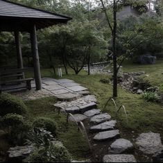 a stone path in the middle of a grassy area