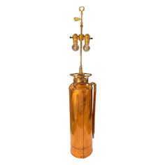 an old fashioned copper colored gas can with two lamps on it's top and bottom