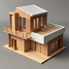 a wooden model of a house with balconies on the second floor and balcony