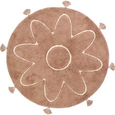 a round rug with tassels on the edges and a flower in the middle