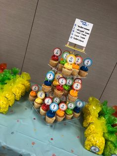 an arrangement of cupcakes and candy on a table