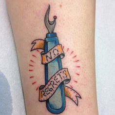 a tattoo on the leg of a person with a wrench and ribbon around it