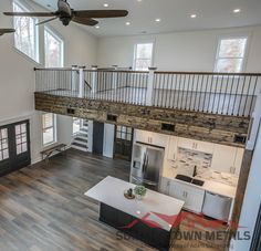 an overhead view of a living room and kitchen in a house with wood flooring