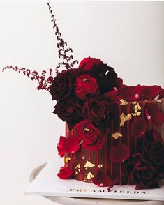 a red and gold cake with flowers on top