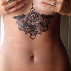 a woman with a tattoo on her stomach