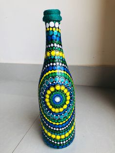 a colorful bottle is sitting on the floor