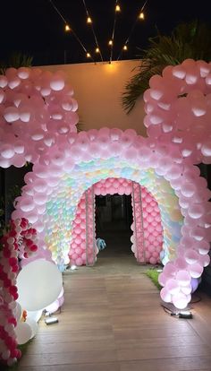 an archway decorated with balloons and flowers