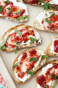 several pieces of bread with cheese and sauce on them