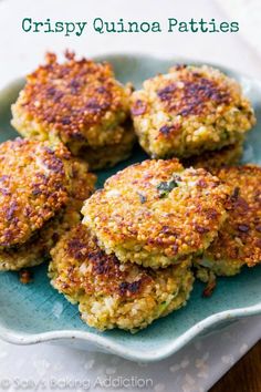 four crab cakes on a plate with the words crispy quinoa patties