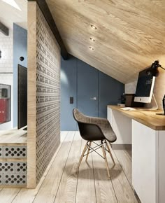 a chair sitting on top of a hard wood floor next to a desk and computer monitor