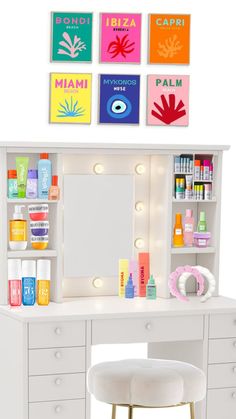 a white desk topped with a mirror and lots of drawers next to a stool covered in bottles