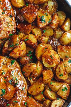 chicken and potatoes in a skillet with gravy on the side, garnished with parsley