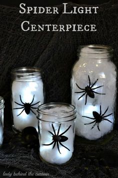 spider light centerpieces in mason jars on a black tablecloth with text overlay that reads, spider light centerpiece