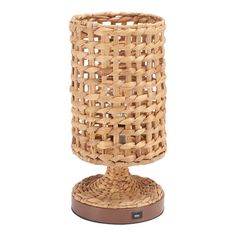 a wicker vase on a stand with a wooden base and brown rubber pad around it