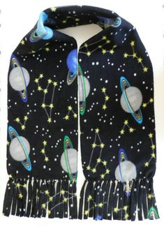 This scarf is handmade with a single layer of fleece with edges stitched and fringe individually knotted.  Size is 9 inches wide and 59 inches long. Each scarf will be slightly different depending on the cut of the fabric.  This fleece fabric is super soft and will keep you nice and warm during the cold winter months! Galaxy Planets, Scarf With Fringe, Fleece Scarf, Space Galaxy, Edge Stitch, Theme Ideas, Inspired Fashion, Winter Months, Cold Winter