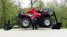 a man standing next to a red four wheeler