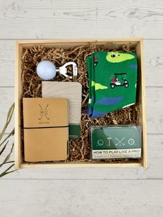 the golf gift box is packed with socks, tees, ball and other items