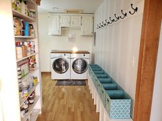 a washer and dryer sitting in a room next to shelves filled with items