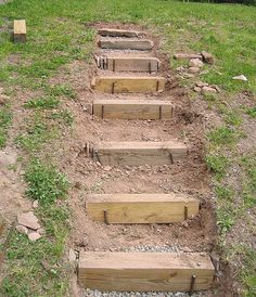 steps made out of wood in the grass