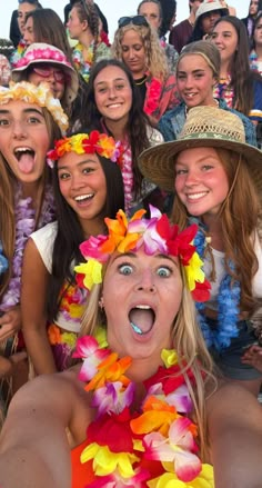 a group of young women wearing leis and hats