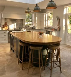 a kitchen with an island and three stools