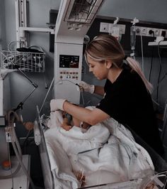 a woman in a hospital bed with an iv machine