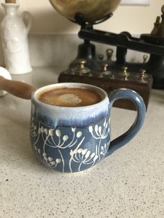 a cup of coffee sitting on top of a counter