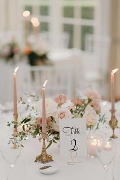 the table is set with candles and flowers