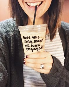 a woman holding a cup with a straw in it and the words does this ring match my look engaged?