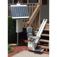 a solar powered chair sitting in front of a stair case