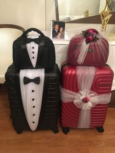 two suitcases decorated with tuxedo and bow ties