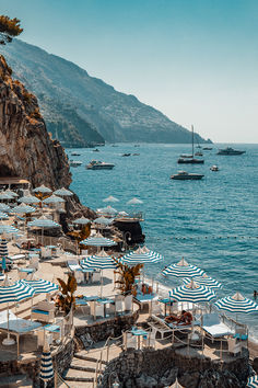 many umbrellas and chairs on the beach